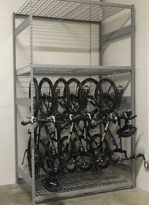a bike rack with 4 bikes hanging on the first shelf