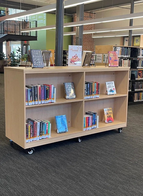 rolling cart holding books in a library